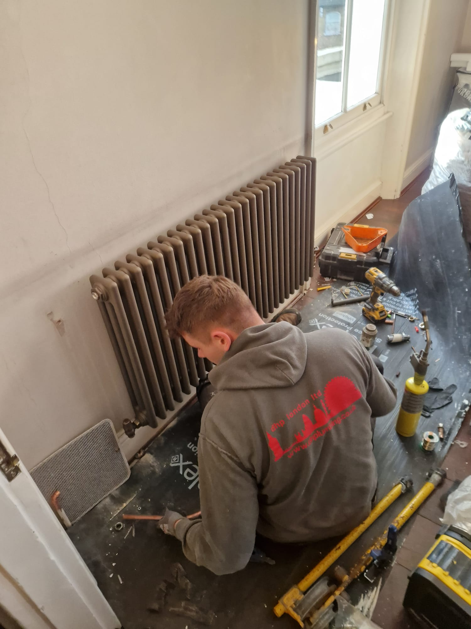 DHP London engineer fitting a column radiator in a period property