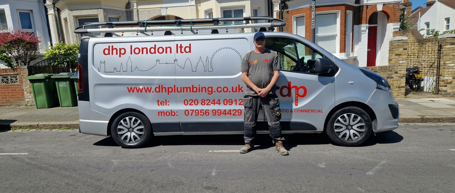 Danny Hensman standing in front of the DHP London Ltd branded van on a residential South East London street