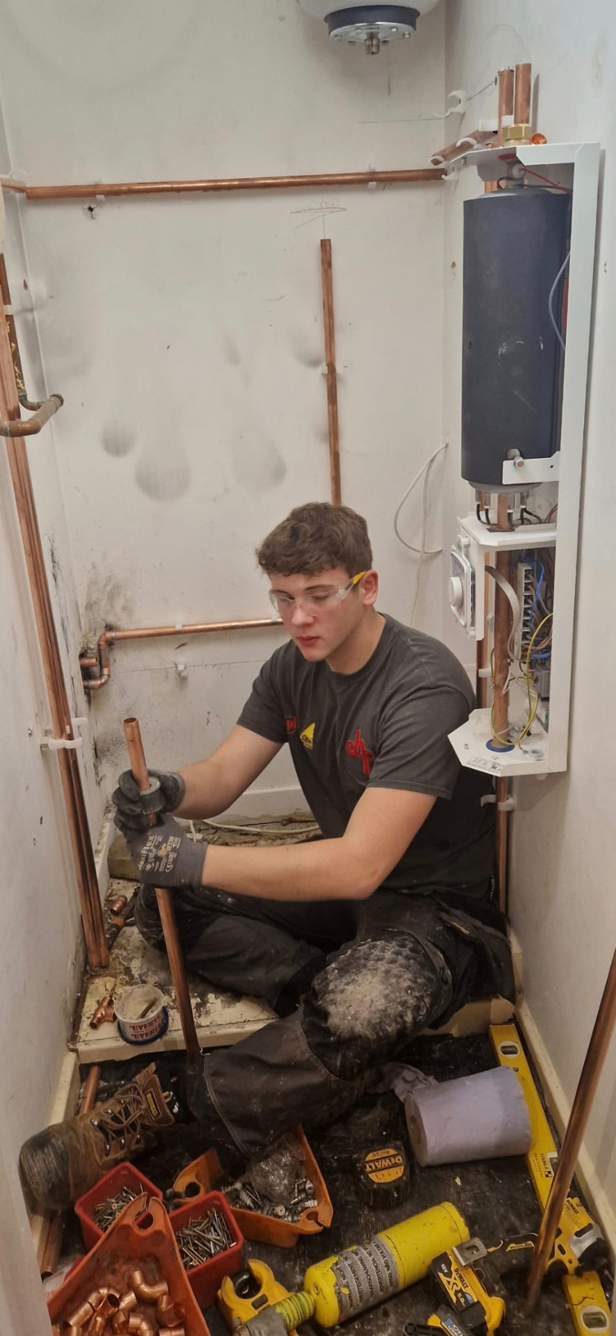 DHP London engineer fitting copper pipework to a new boiler installation